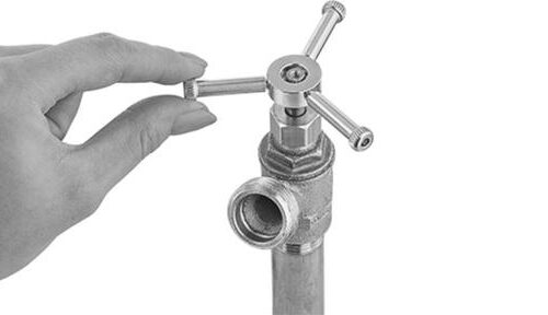 Hero_image Hand turning a chrome-plated industrial valve handle on a threaded pipe fitting of McMaster-Carr