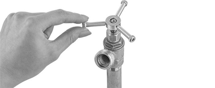 Hand turning a chrome-plated industrial valve handle on a threaded pipe fitting of McMaster-Carr
